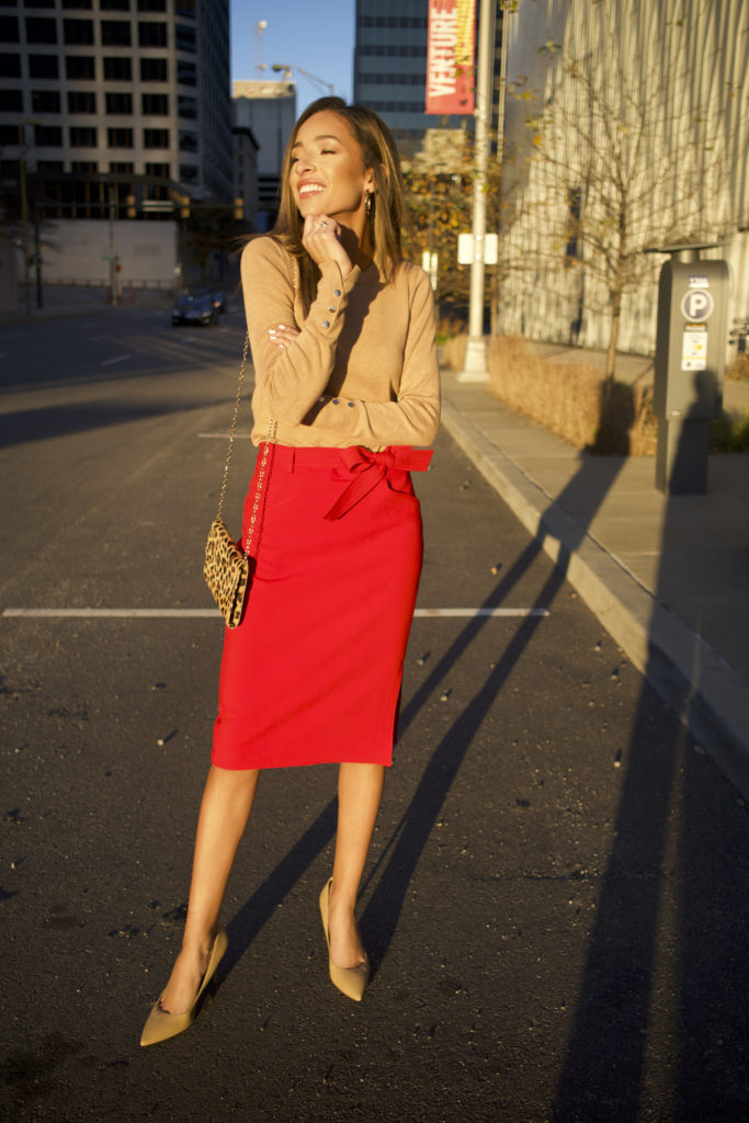 woman wearing red pencil skirt and tan sweater