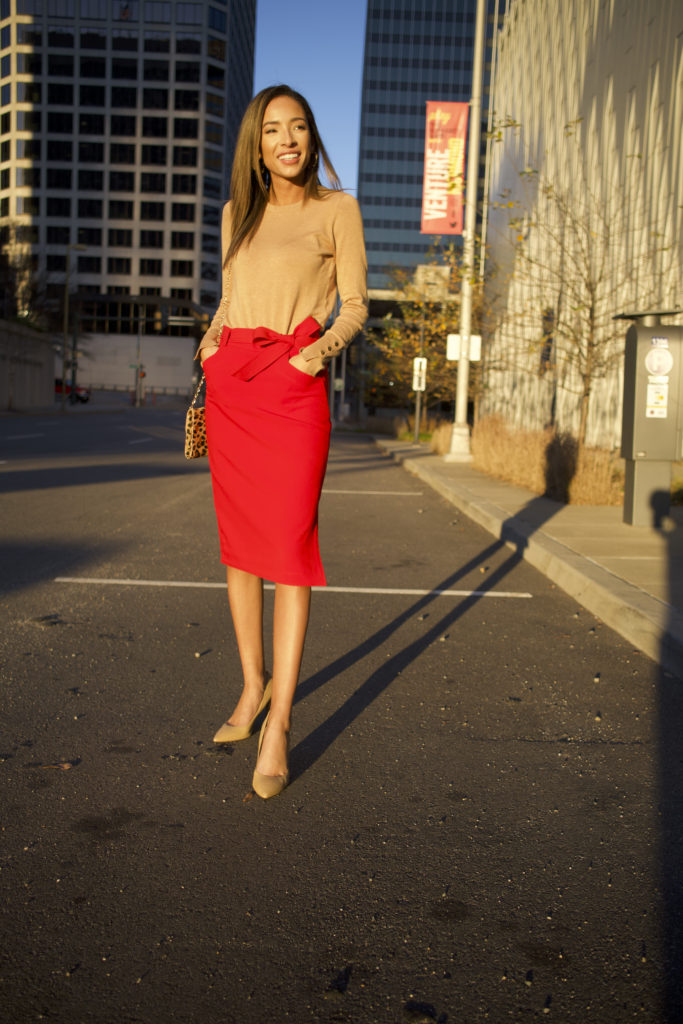 woman wearing red pencil skirt and tan sweater