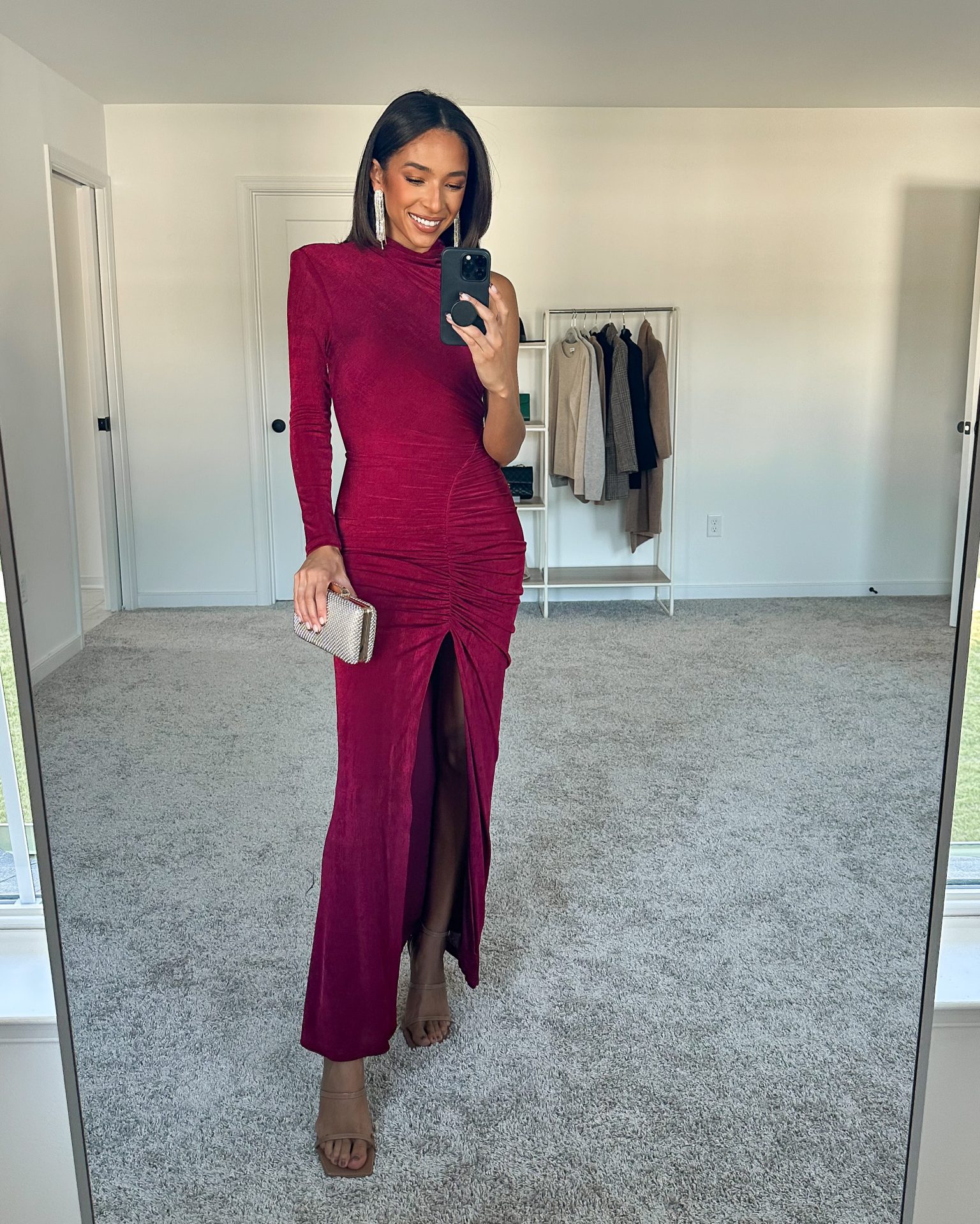 Nena Evans wearing a berry long sleeve gown for a black tie fall wedding 