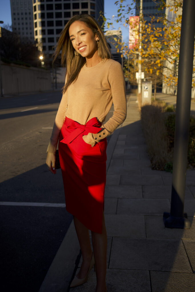 woman wearing red pencil skirt and tan sweater