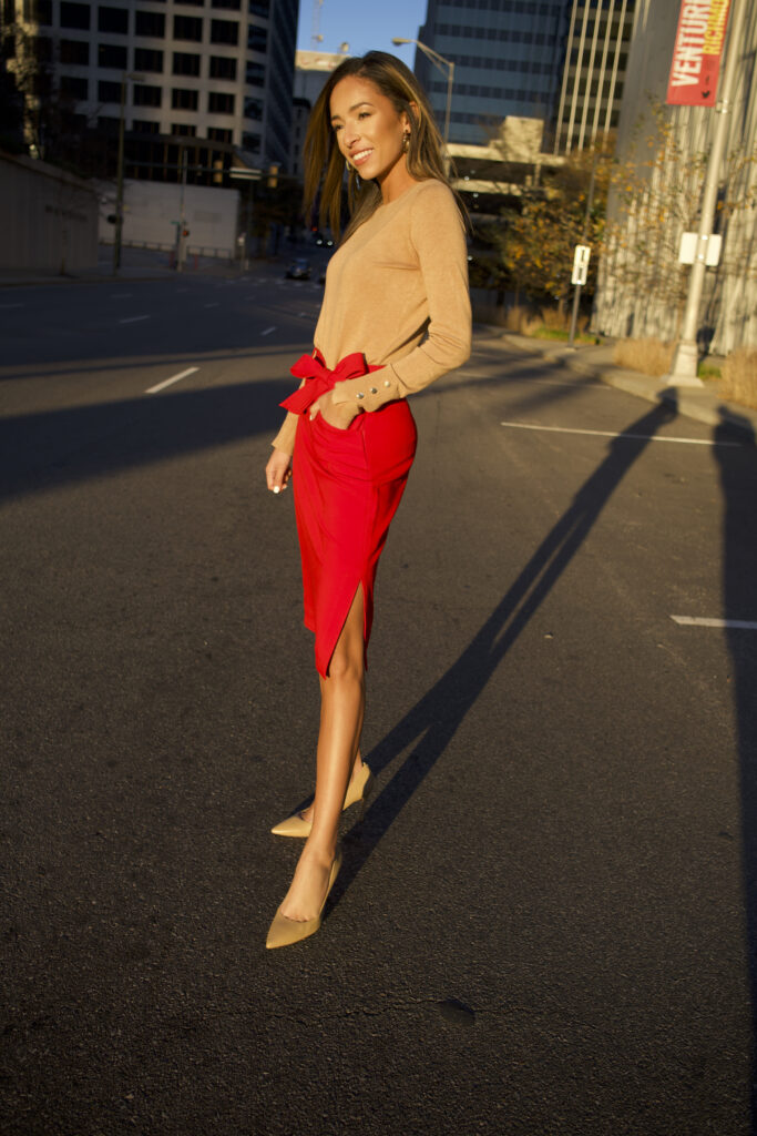 woman wearing red pencil skirt and tan sweater